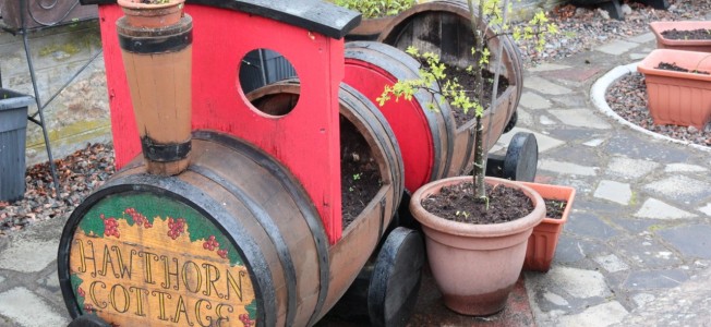 We saw quite a few of these garden decorations/planters made of old casks and thought they were pretty  awesome.